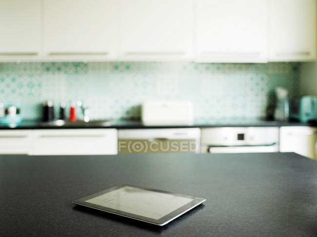 Digital tablet on kitchen counter — Stock Photo
