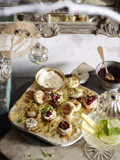 Sage and mustard chicken patties with micro herbs and cranberry relish — Stock Photo
