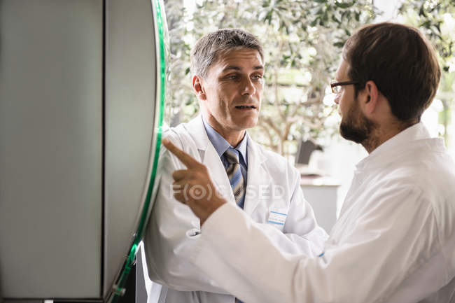 Doctors using glass panel — Stock Photo