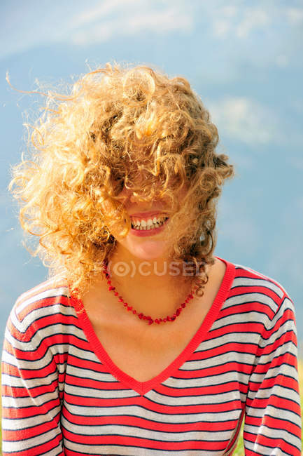 Sorrindo cabelo feminino soprando no vento — Fotografia de Stock