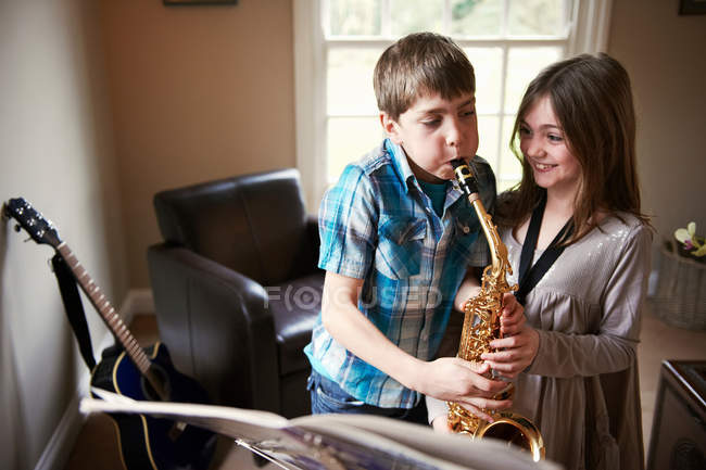 Children playing with saxophone — Stock Photo
