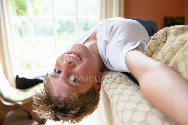 Boy lying on back looking at camera — Stock Photo