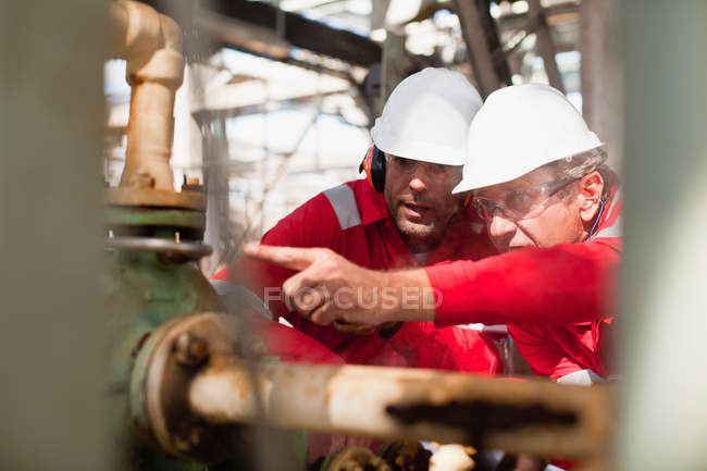 Workers examining equipment on site — Stock Photo