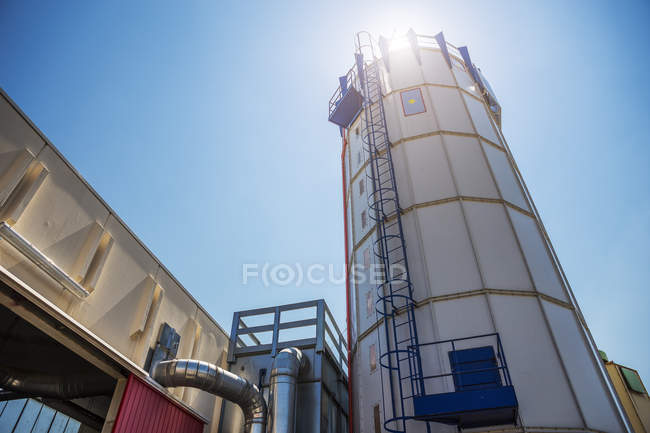 Sawdust extractor at factory in bright sunlight — Stock Photo