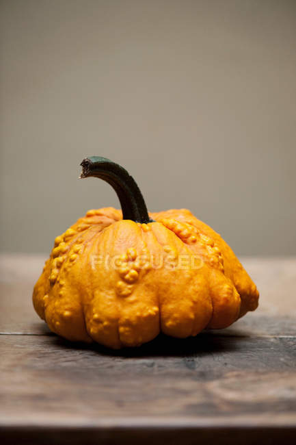 Close up of yellow gourd on table on wood — Stock Photo