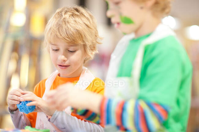 Boys using modelling clay — Stock Photo