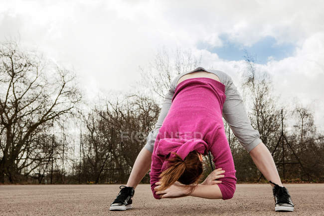 Woman doing bending forward exercise — Stock Photo