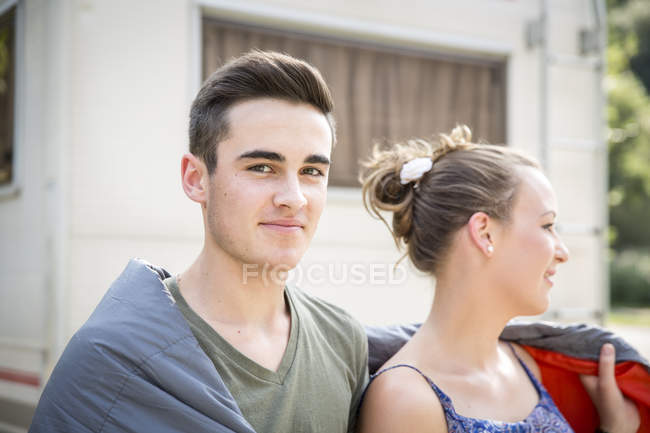 Young couple wrapped in blanket, outdoors — Stock Photo