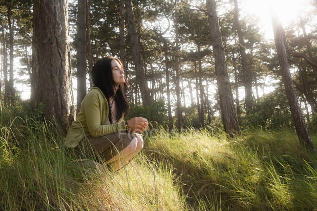 Woman crouching in contemplation — Stock Photo