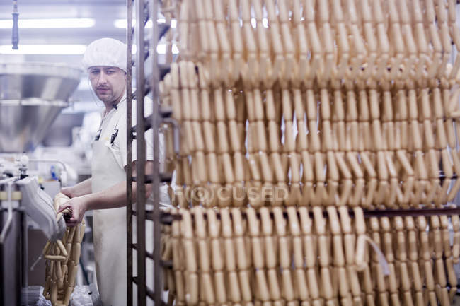 Factory worker making tofu sausages — Stock Photo