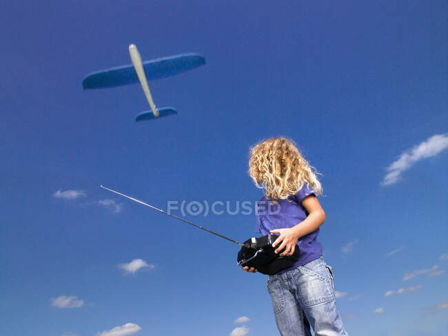 Young girl with remote-control — Stock Photo