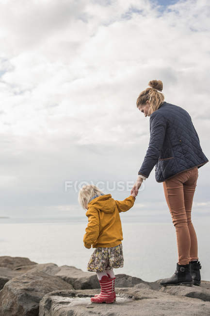 Mãe e criança andando na parede do porto — Fotografia de Stock
