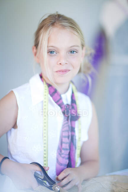 Girl using pair of scissors — Stock Photo