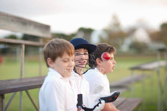 Boys on bleachers at cricket pitch — Stock Photo