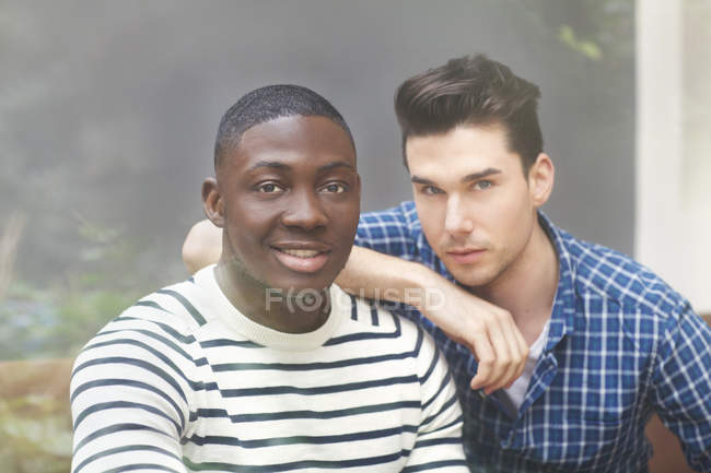 Portrait of two young men behind window — Stock Photo