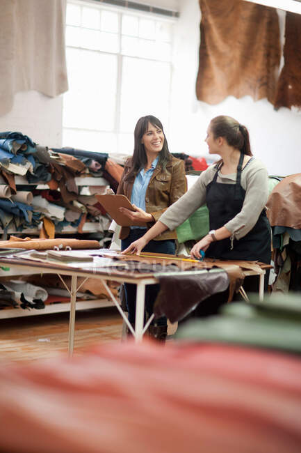 Worker and manager in leather workshop — Stock Photo