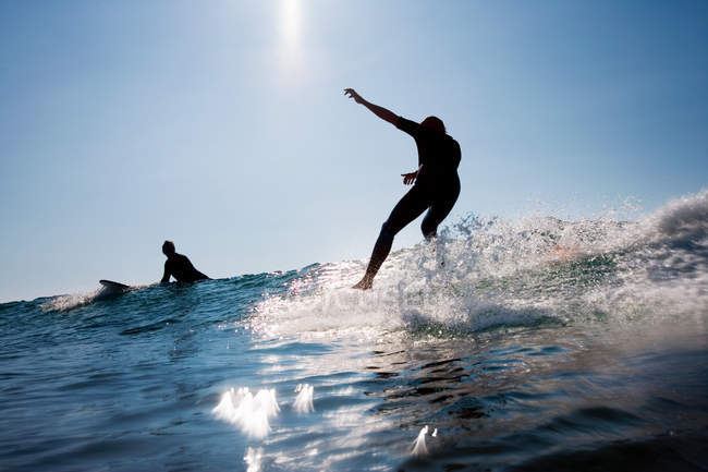 Two men surfing at constantine bay in sunlight — Stock Photo