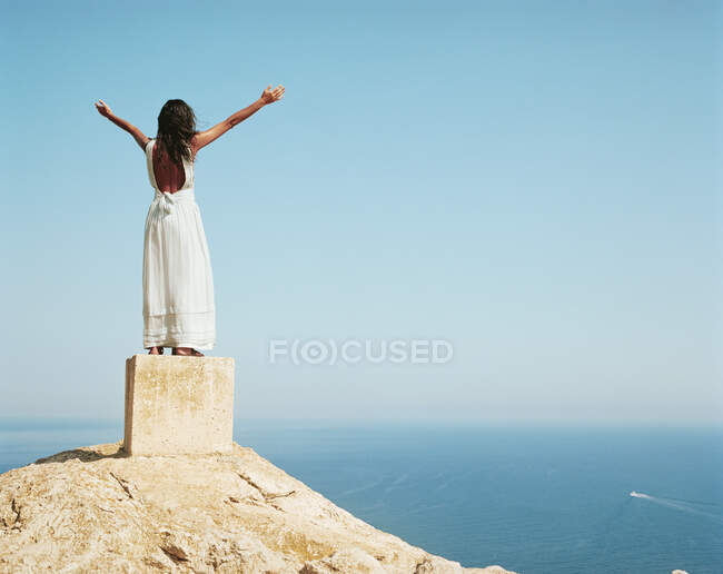 Woman standing on a large cement block — Stock Photo