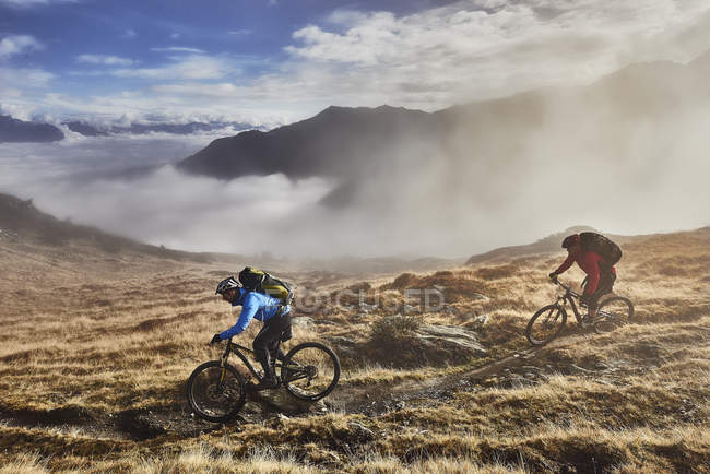 Mature men mountain biking, Valais, Switzerland — Stock Photo