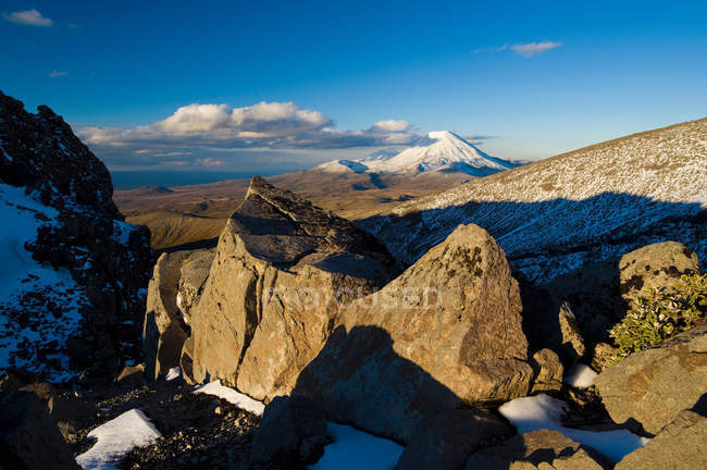 Shadows over rocks in snowy landscape — Stock Photo