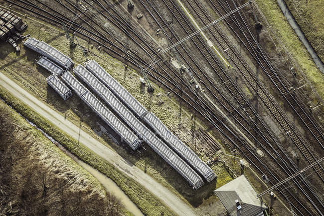 Aerial view of train tracks and railway carriages in sunlight — Stock Photo