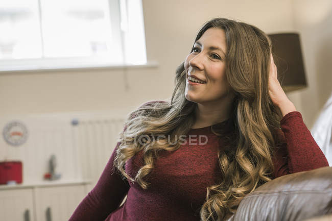 Woman relaxing at home and looking away — Stock Photo