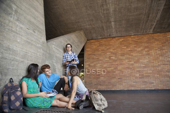 Three students talking with each other — Stock Photo
