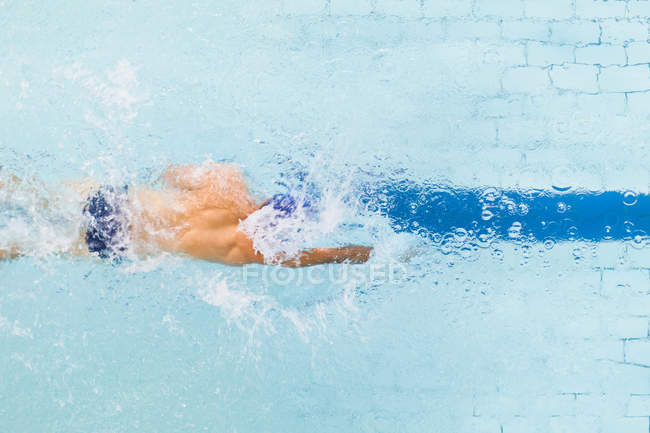 High angle view of swimmer following pool lane — Stock Photo