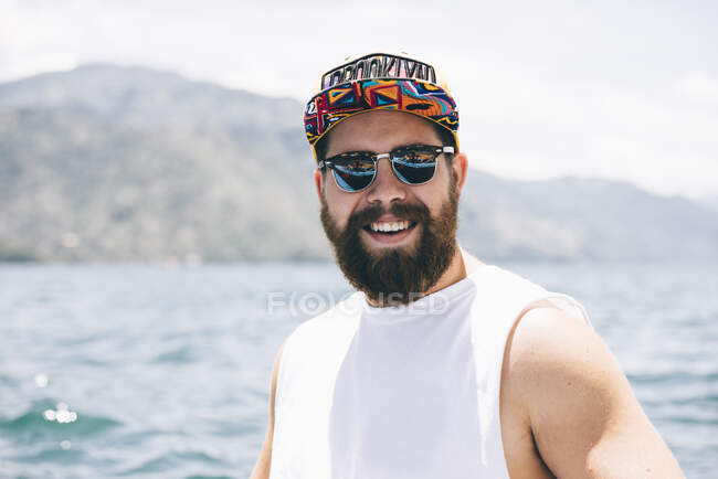 Portrait of young man in front of Lake Atitlan, Guatemala — Stock Photo