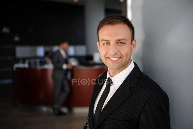 Portrait of mid adult businessman in office — Stock Photo