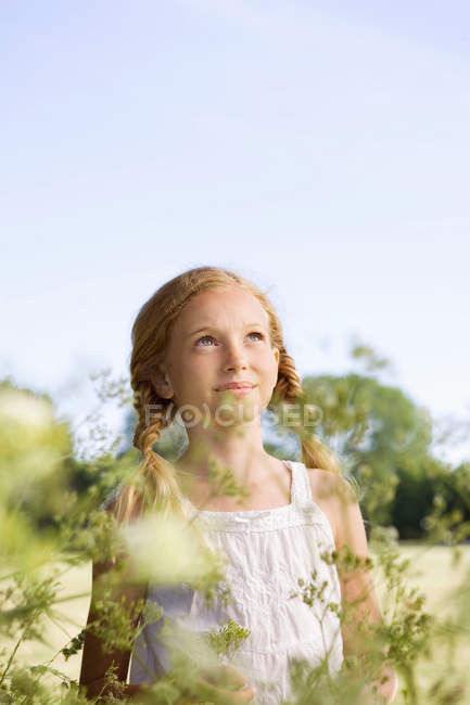 Portrait of young girl with flowers — Stock Photo