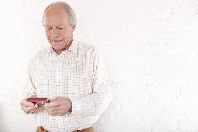 Senior man holding digital camera — Stock Photo