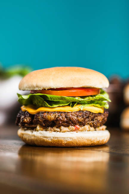 Close up shot of cheeseburger on table — Stock Photo