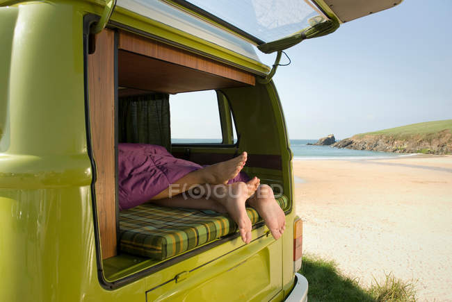 Couple lying in camper van — Stock Photo