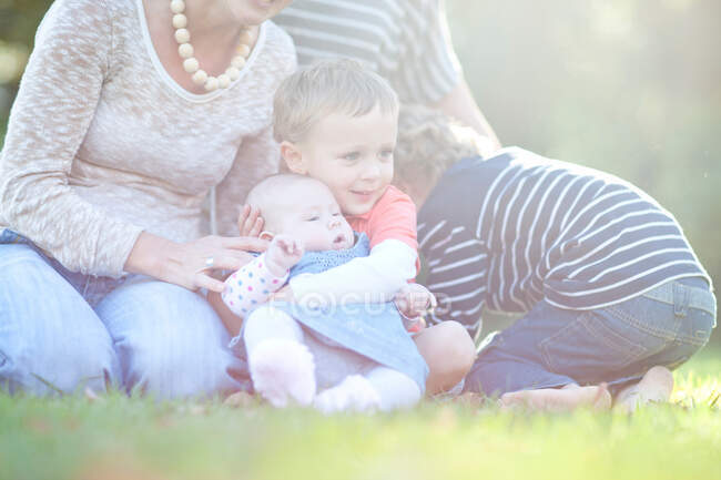 Мальчик держит младшую сестру — стоковое фото