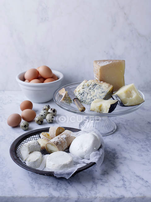 Cheese and eggs on table — Stock Photo