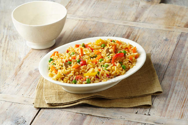 Savoury rice in white serving dish — Stock Photo