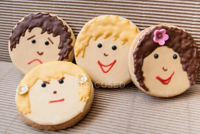 Cookies decorated with faces made of icing sugar — Stock Photo