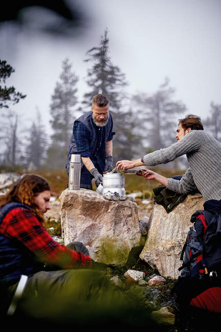 Туристы, готовящие кофе в лагере, Лапландия, Финляндия — стоковое фото