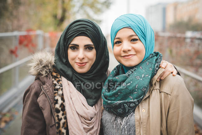 Portrait of two young female friends on park path — Stock Photo