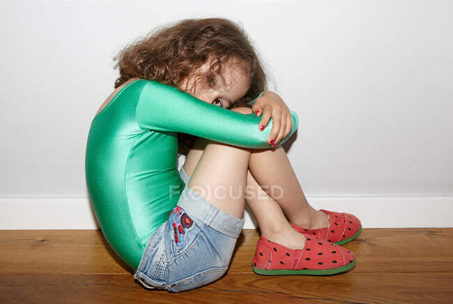 Child on floor in fetal position — Stock Photo