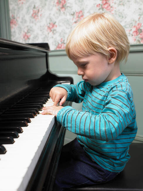 Petit garçon jouant du piano — Photo de stock