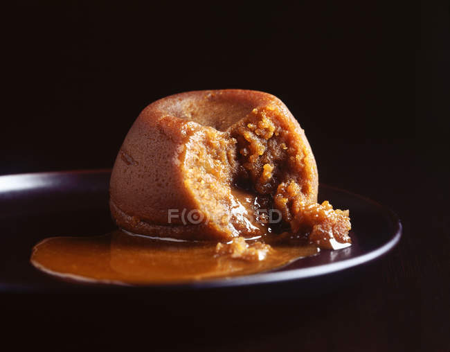 Pudding au caramel collant avec sauce sur assiette — Photo de stock