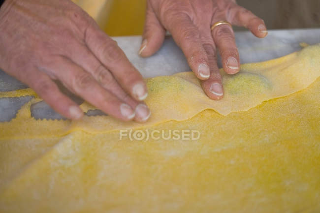 Cropped image of woman forming pasta dough — Stock Photo