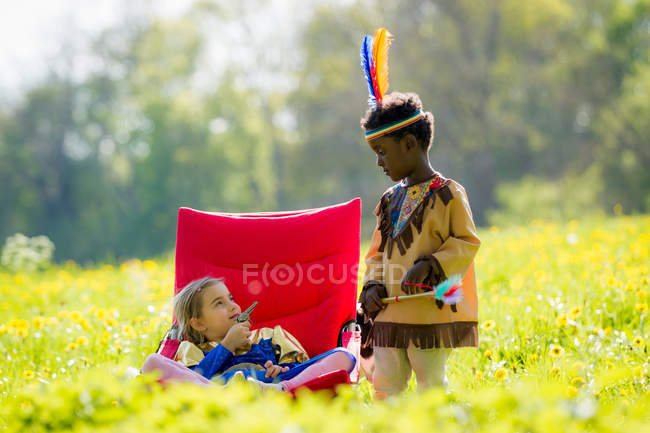 Children playing dress up outdoors — Stock Photo