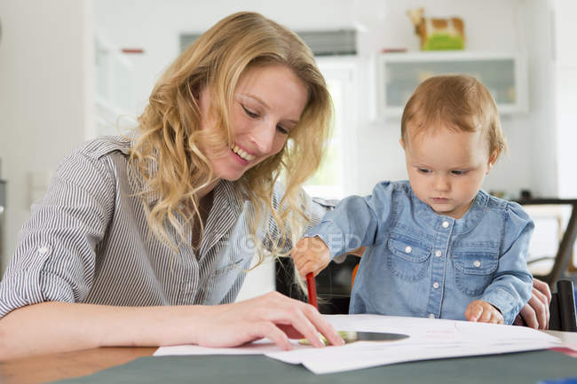 Baby girl drawing with mother at home — Stock Photo