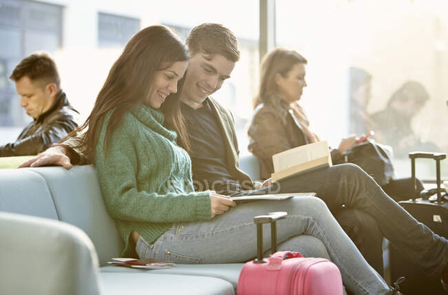 Young couple in departure lounge — Stock Photo