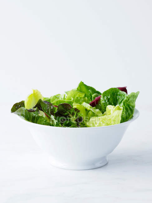 Mixed salad leaves in white bowl — Stock Photo