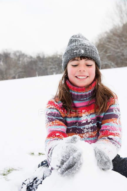 Дівчина будує сніговика взимку — стокове фото