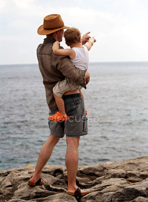 Father holding son outdoors — Stock Photo